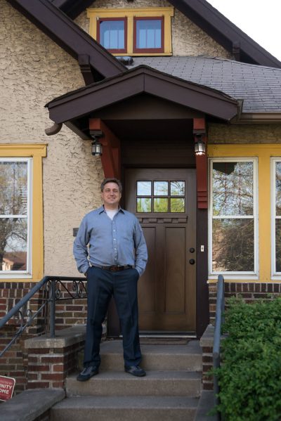 jeff in front of door of yellow house
